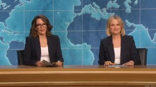 Tina Fey and Amy Poehler recreating SNL's Weekend Update at the 75th Emmy Awards.