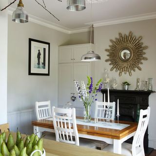white dining room with dining table and cupboard