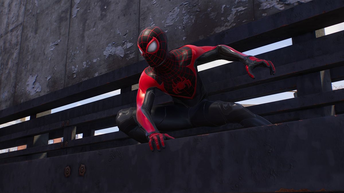 Spider-Man (Miles Morales) crouching on a ledge at the Raft super-prison in Spider-Man 2.