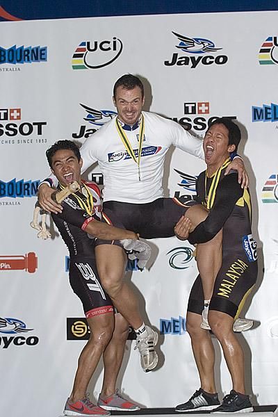 A little bit of Malaysian muscle: Malaysian placegetters in the keirin final attempt to lift gold medallist Carsten Bergamann on the podium.