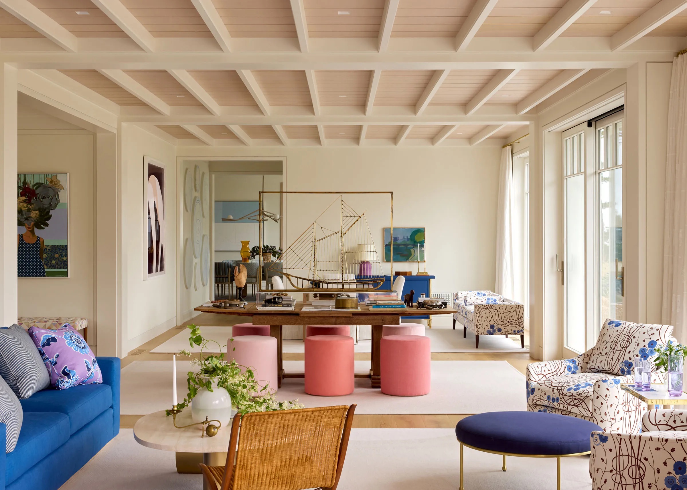 A contemporary living room with a central table full of nautical and sea-themed objects