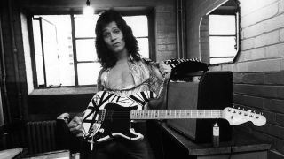 Eddie Van Halen holding a guitar backstage at Lewisham Odeon in 1978