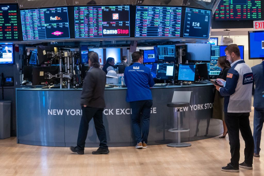 People stand around the floor of the New York Stock Exchange. 