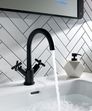 black bathroom tap with white tiles