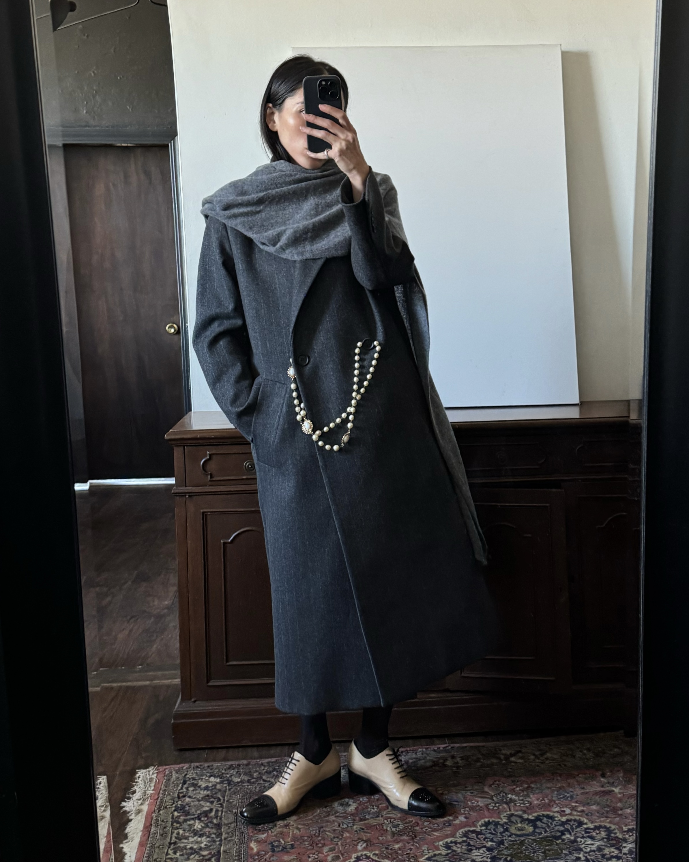 Alexis Badiyi wearing a gray coat with a scarf