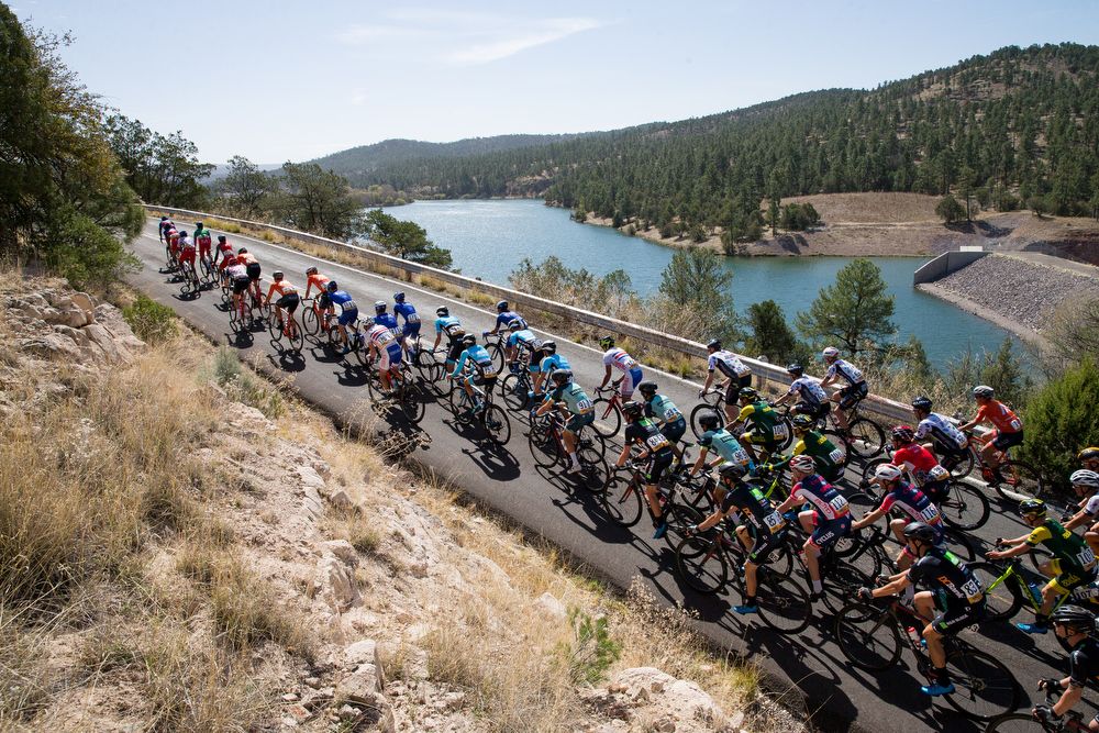 The peloton passes a lake during stage 2 at the Tour of the Gila.