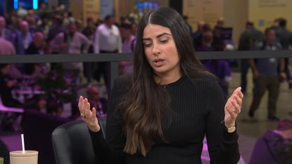 Asha Sharma in black sweater