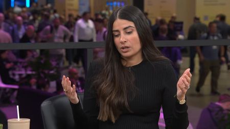 Asha Sharma in black sweater