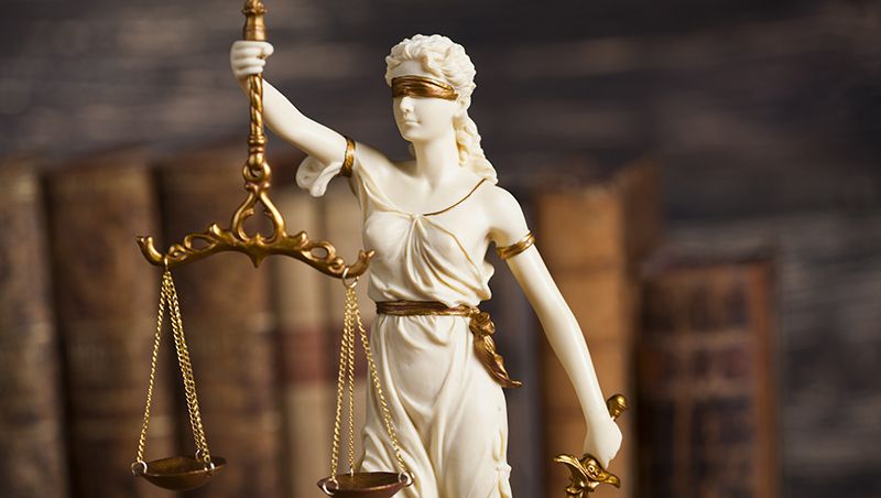 Statue of a woman holding scales of justice