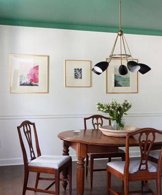 dining room with white walls, green ceiling and traditional furniture