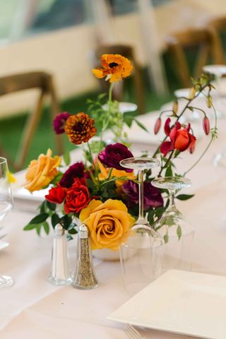 cut flowers on table in small vase at garden wedding