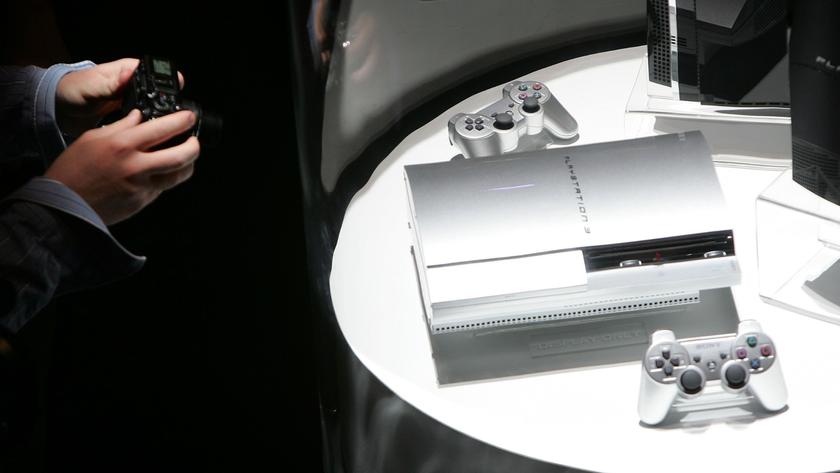 a silver Sony PlayStation 3 being photographed
