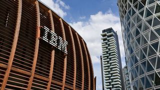 A view of a building with the IBM logo displayed on the front, surrounded by skyscrapers