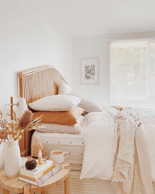 Cozy minimal bedroom with pumpkin tones and layered cotton pillows on bed