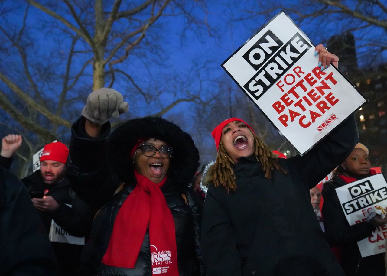 Nurses holding protest signs in New York