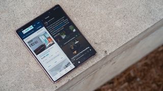 Samsung Galaxy Z Fold 2 in tablet mode on a concrete sidewalk