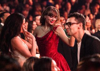 Taylor Swift dancing in a sparkly red dress at the Grammys on February 02, 2025