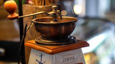 A close up of an antique coffee grinder