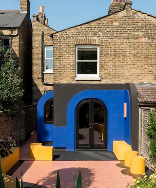 small kitchen extension with contemporary blue and black curved panelled exterior finish