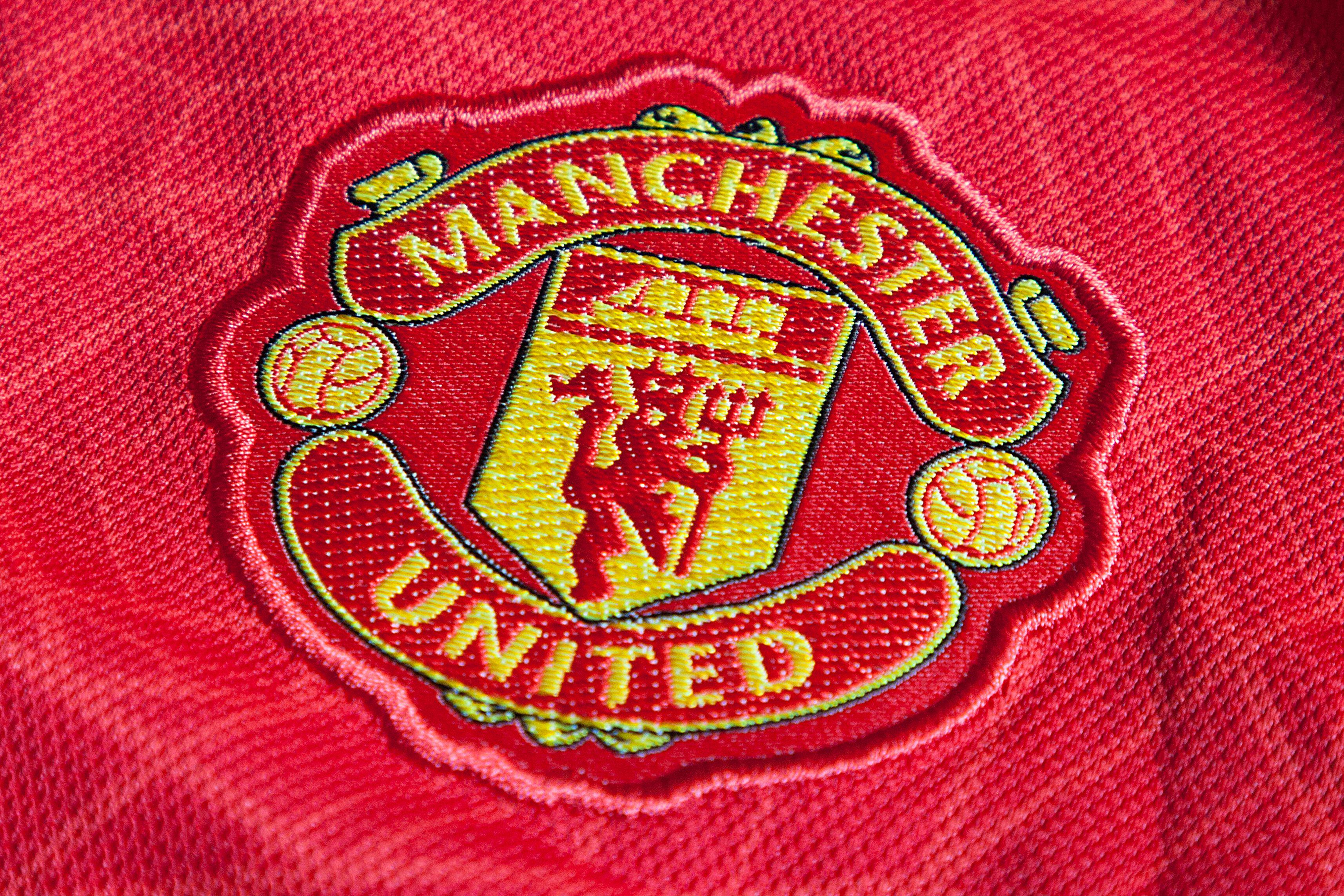 The Manchester United badge on a red shirt