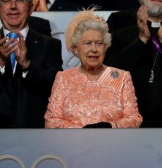 Queen Elizabeth wearing a peach dress at the 2012 Olympics