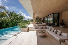 Sunset Islands Residence by Strang Design view of indoor outdoor relationship in living space and swimming pool