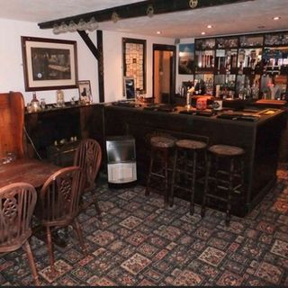 pub with white wall carpet flooring and photo frame on wall