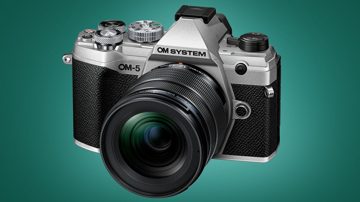 The OM System OM-5 camera on a green background