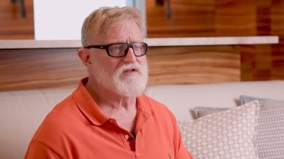 Gabe Newell in an orange shirt