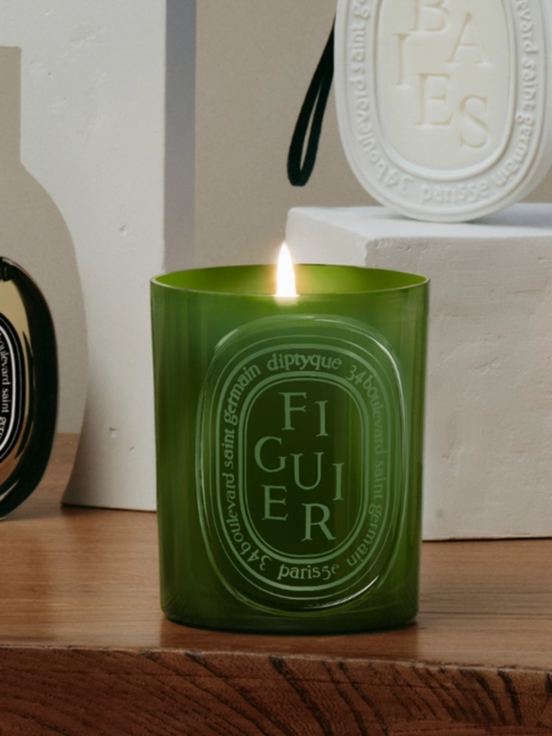 A green glass candle from Diptyque
