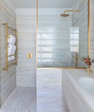 Small wet room with marble floor and wall