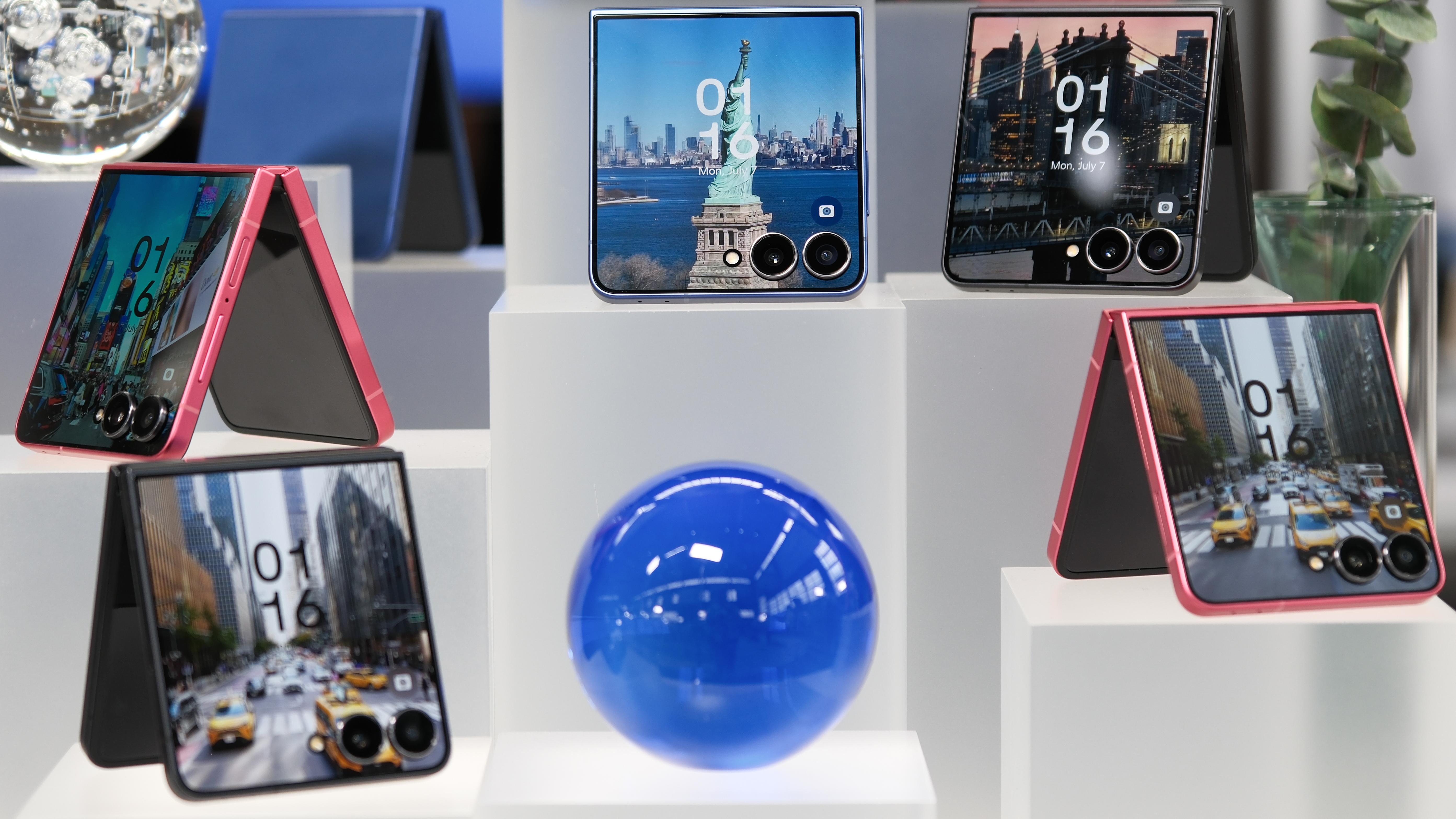 Samsung Galaxy Z Flip 7 on display with numerous devices showing New York City scenes on the cover display