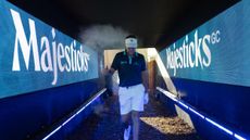 Ian Poulter walking through a tunnel with Majesticks GC branding