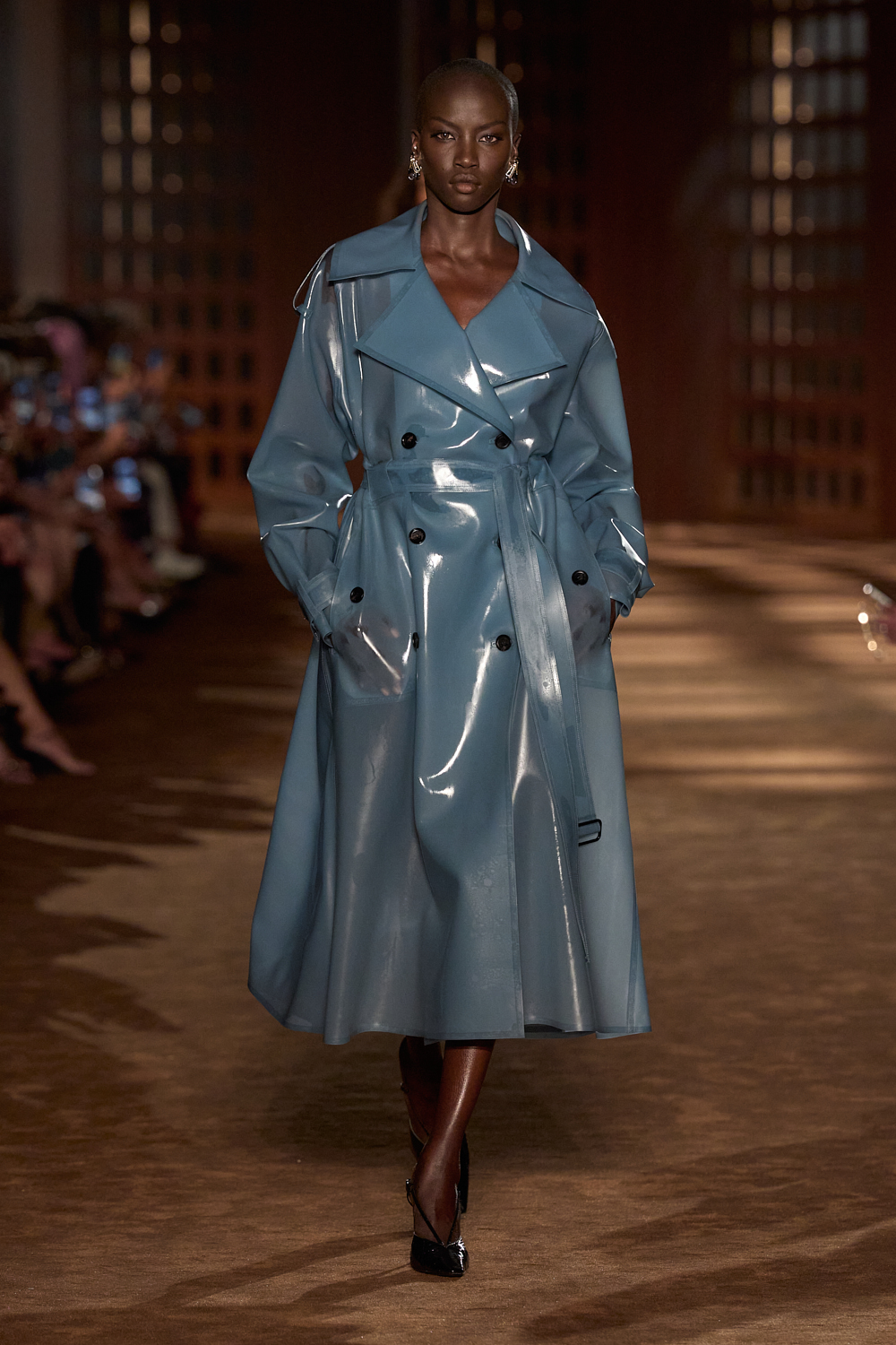 a model wears latex while walking the ferragamo spring 2027 runway.
