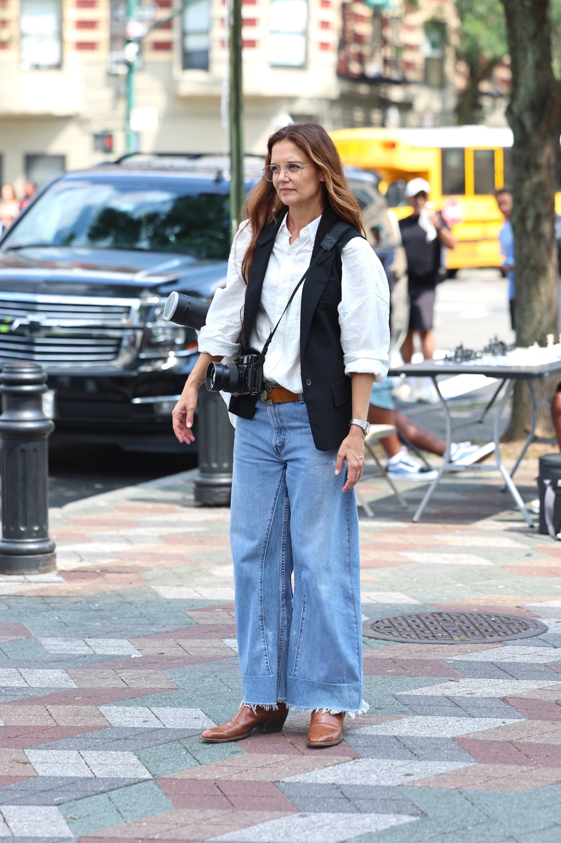 Katie Holmes arrived on the set of 'Happy Hours' in a billowy white button-down, baggy jeans, and cowboy boots.