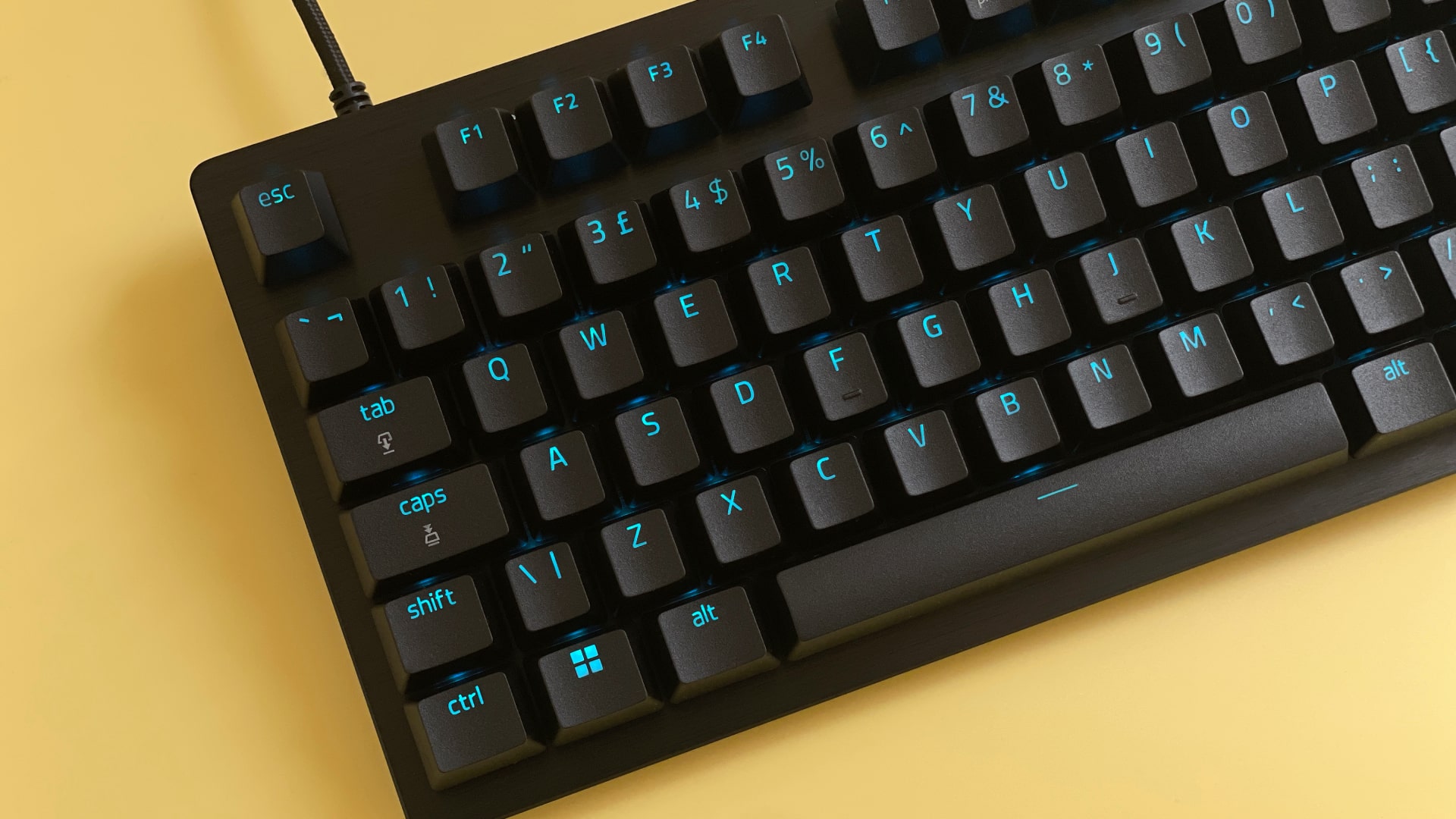 The Razer Huntsman V3 Pro Tenkeyless mechanical gaming keyboard against a yellow background.