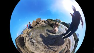 Playing on a beach rock pool in wide angle