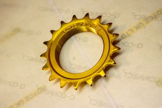 A gold titanium Royce track sprocket