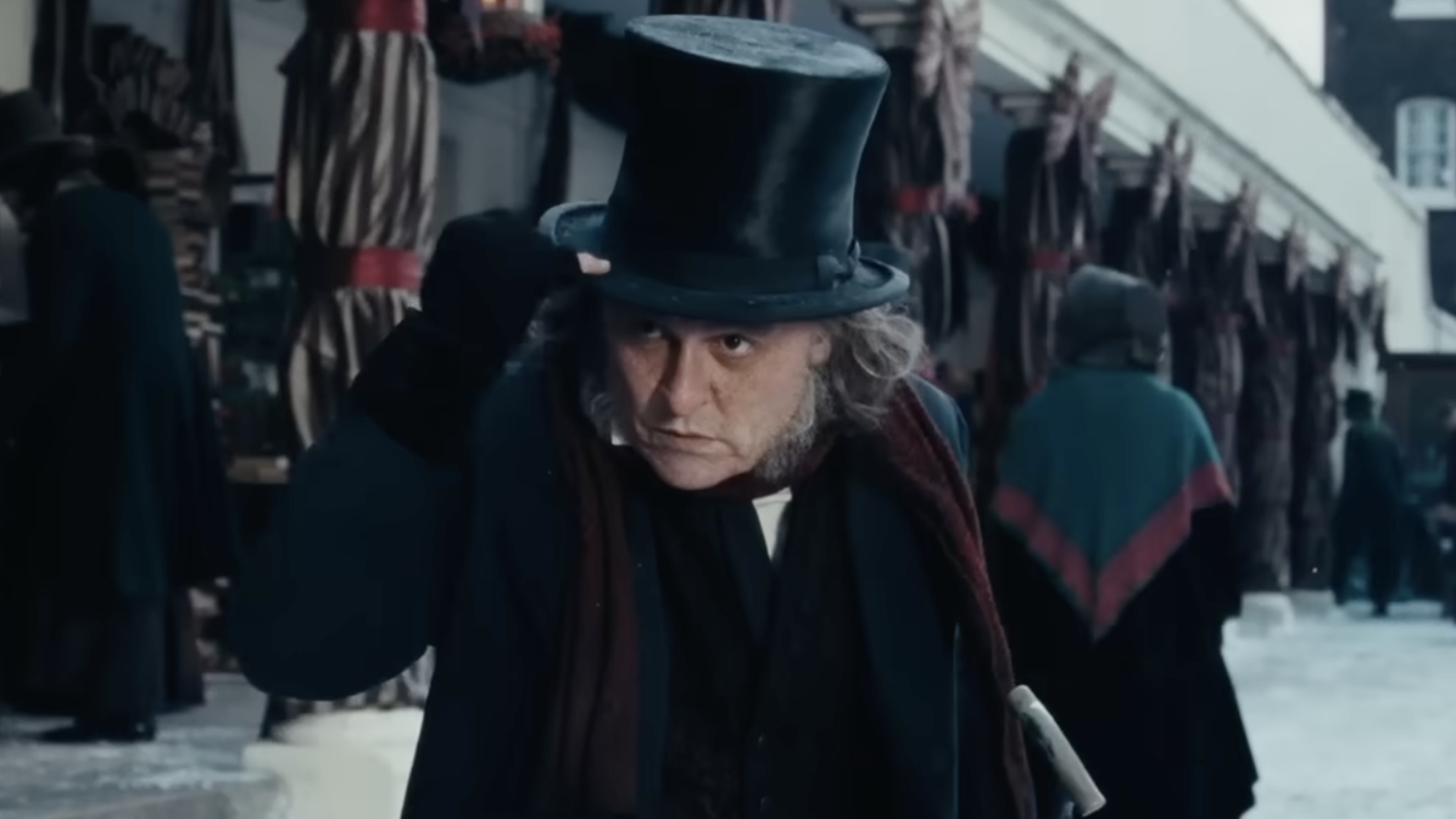 Johnny Depp as Ebenezer Scrooge tipping his hat in Ebenezer. 