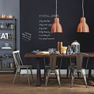 kitchen room with wooden flooring and black board on wall