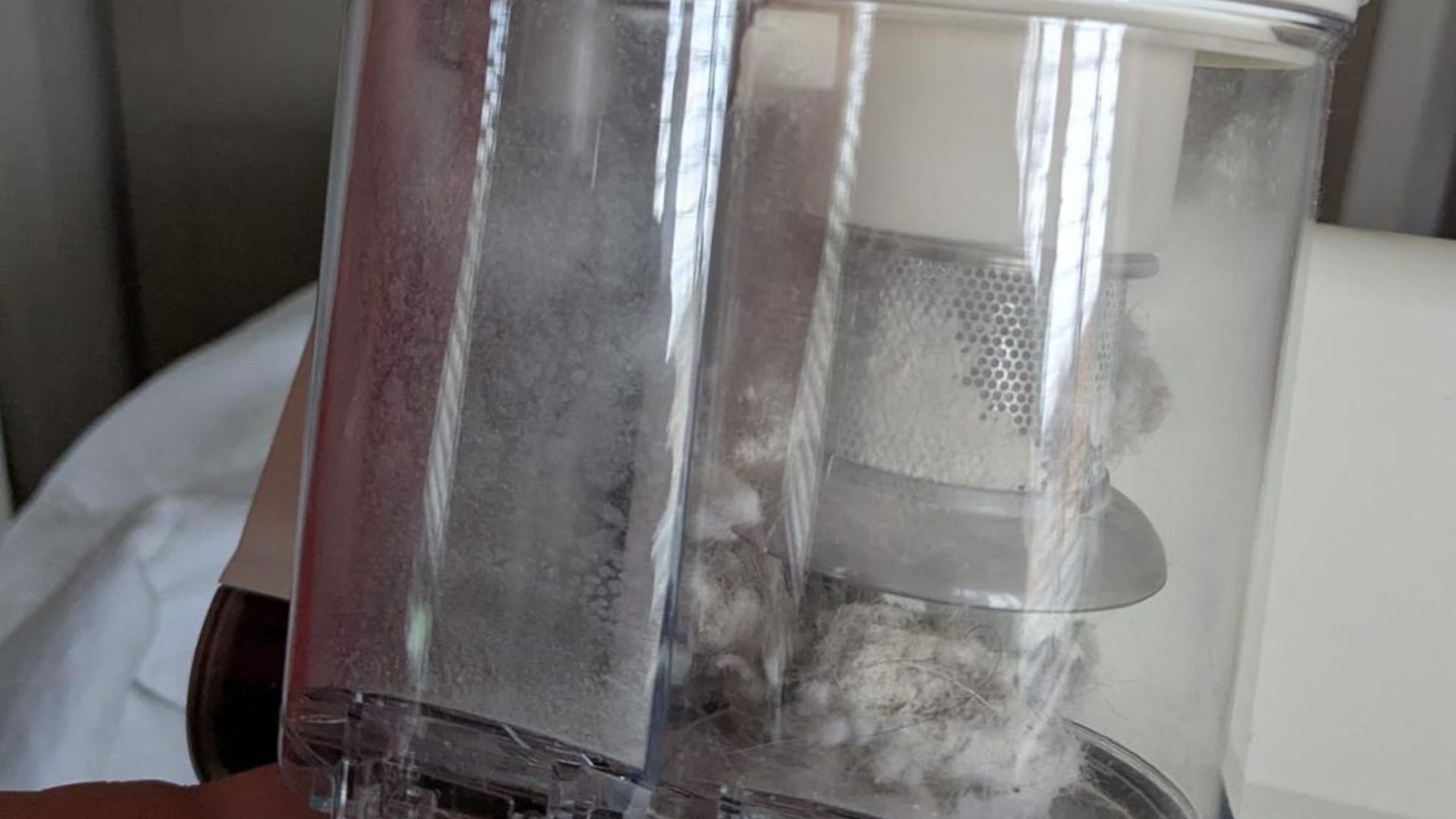 Our tester uses the white FEPPO Mattress Vacuum Cleaner to remove fine dust and particles from inside her mattress and pillow