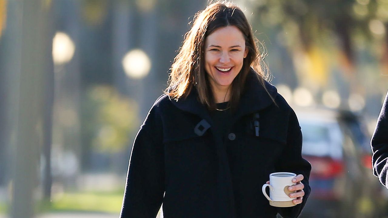 Jennifer Garner smiling and holding coffee cup