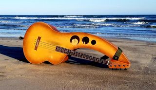 Troy Johnson's upright bass sits on a beach