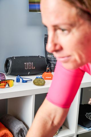 Image shows a cyclist riding indoors with music