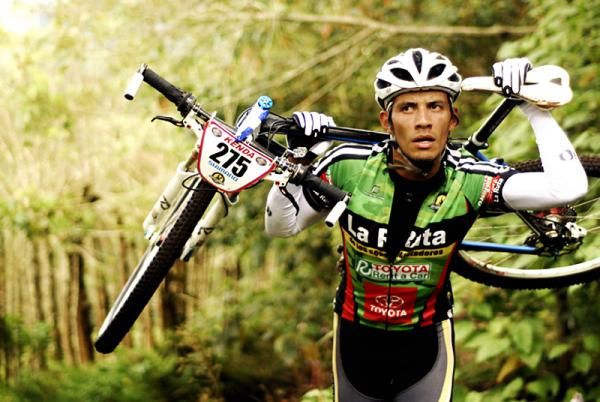 Eddy Perez carries his bike
