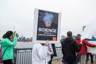 Hundreds of community members from Harvard University and MIT march across the Massachusetts Avenue Bridge to join the March for Science at the Boston Common on April 22, 2017 in Boston, Massachusetts.