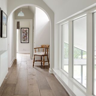 room with photoframe on white wall and wooden flooring