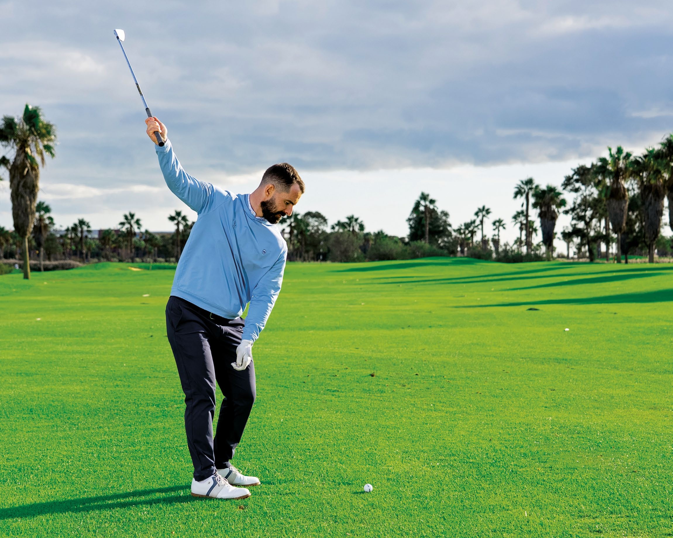James Jankowski at the top of the backswing in the trail arm only drill, with just his trail hand on the club