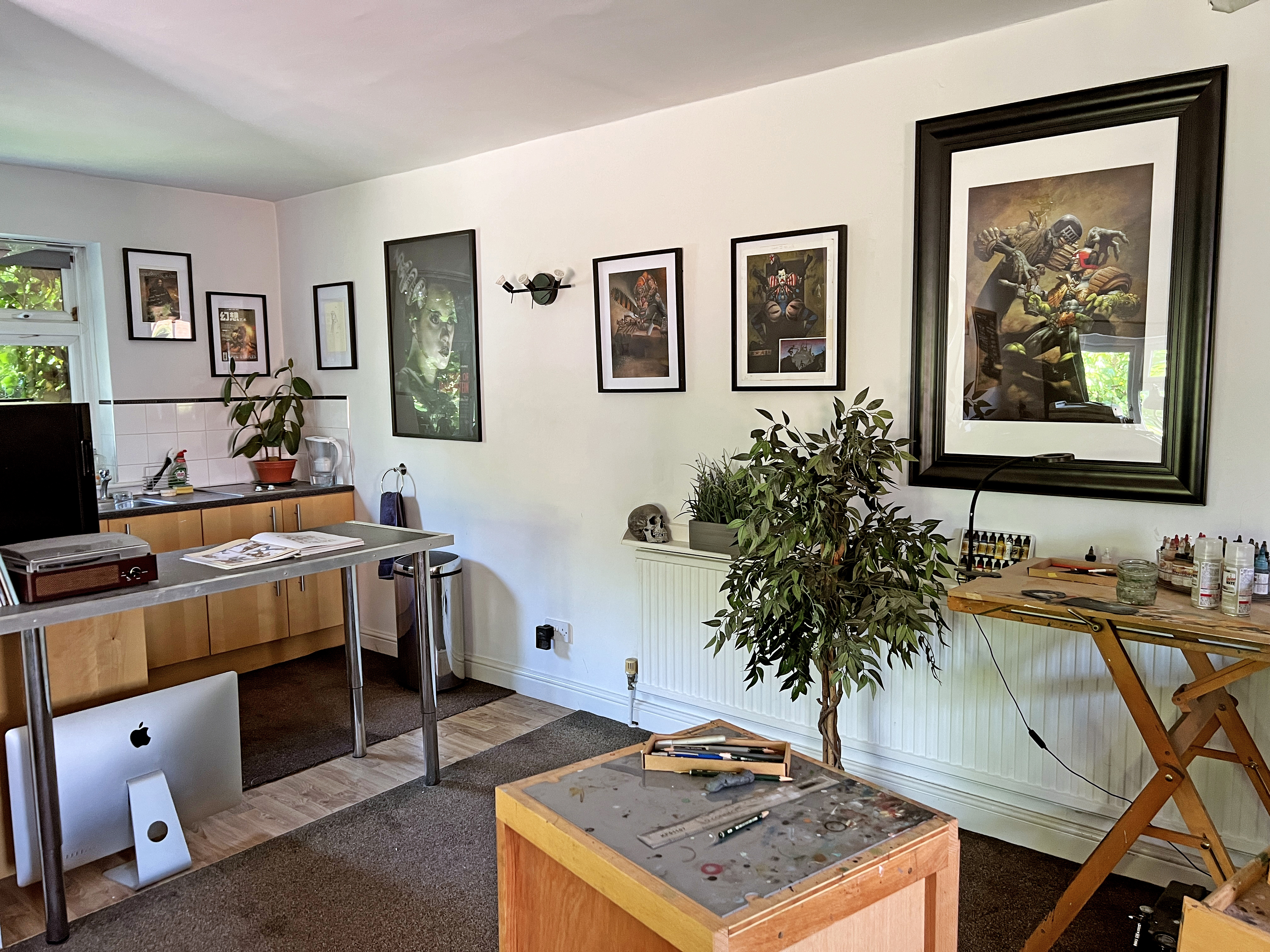 An artist's studio with paintings on the walls