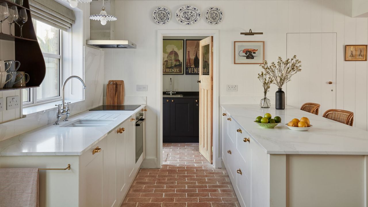 narrow kitchen with rustic brick flooring